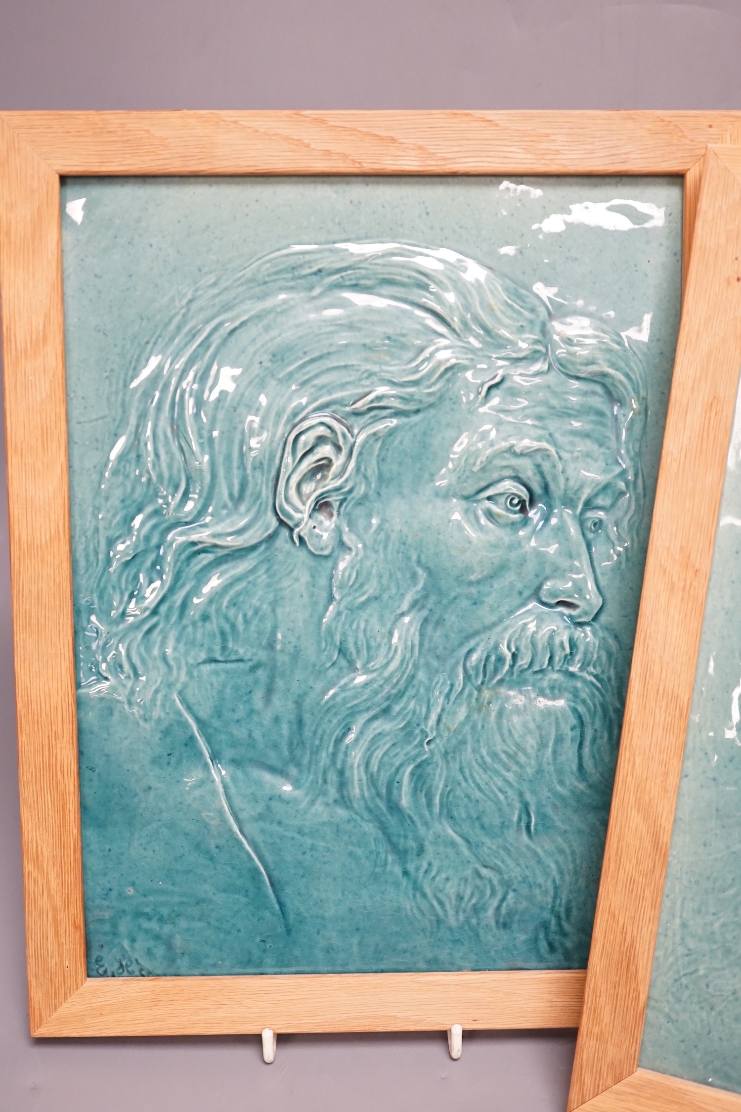 A pair of Burmantofts relief-moulded turquoise glazed portrait plaques, late 19th century, modern oak frames. 30x23cm
